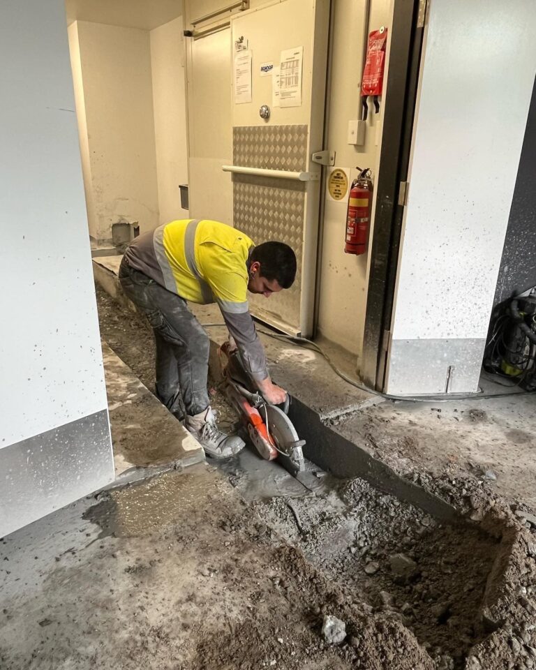 Plumber working on floor cutting — Plumbing Contractors in Brisbane, QLD