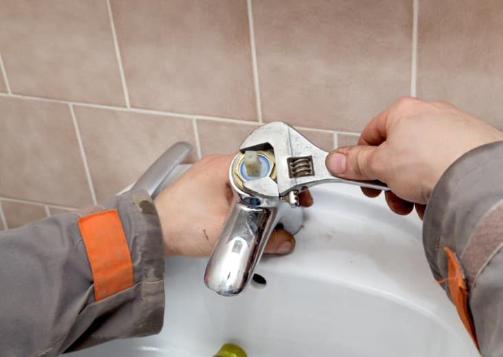 Fixing faucet — Plumbing Contractors in Wamuran, QLD