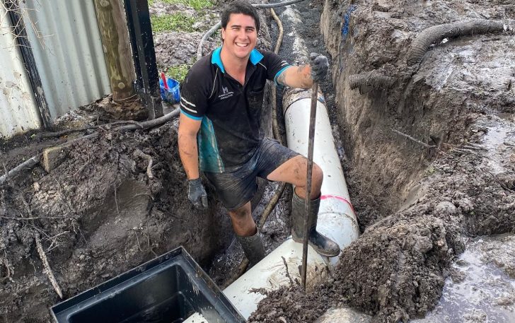 Happy plumber working on a big pipeline — Plumbing Contractors in Beerwah, QLD