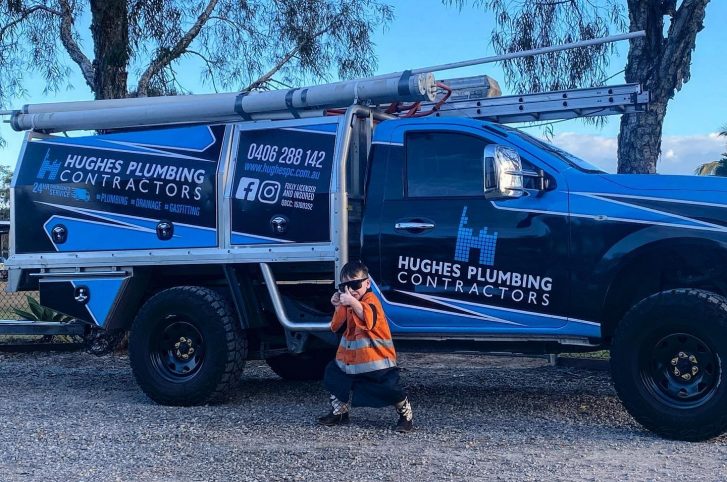 Kid beside service truck — Plumbing Contractors in Elimbah, QLD
