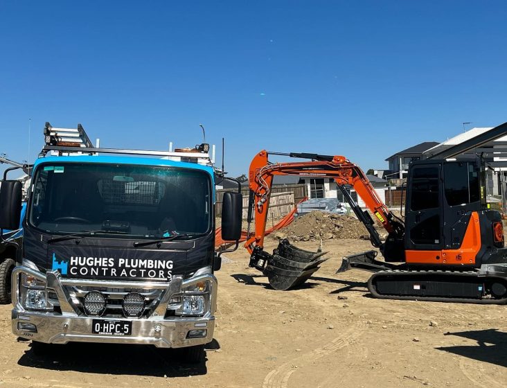 Service truck beside excavator — Plumbing Contractors in Brisbane, QLD