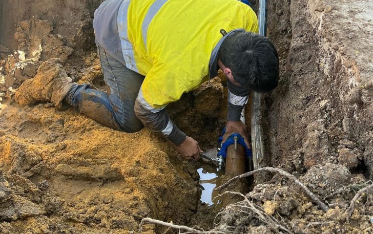 Plumber working on waterline underground — Plumbing Contractors in Narangba, QLD