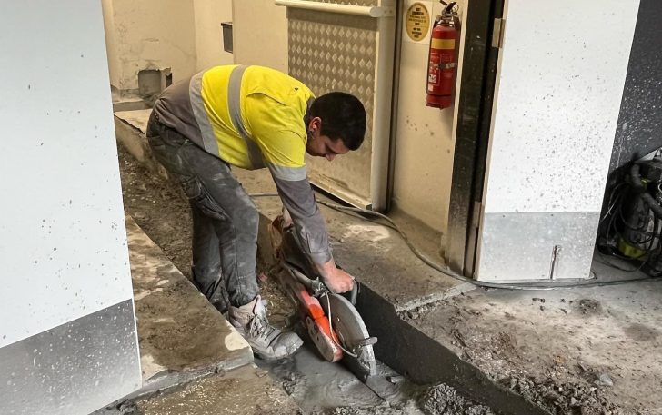 Plumber working on floor cutting — Plumbing Contractors in Morayfield, QLD