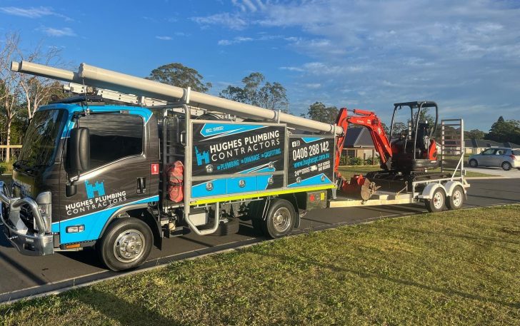 Service truck pulling mini excavator — Plumbing Contractors in Burpengary, QLD