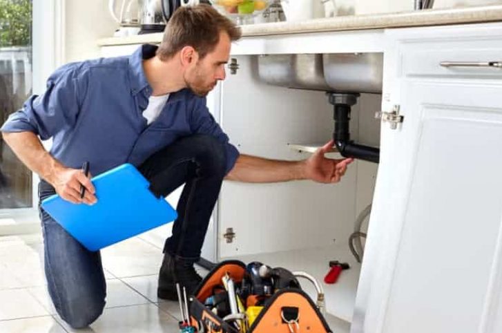 Plumber checking sink drain line — Plumbing Contractors in Caboolture, QLD
