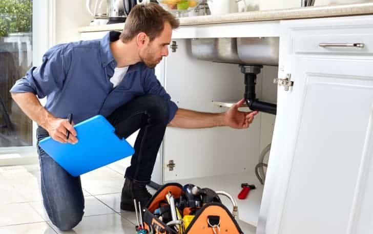 Plumber checking sink drain line — Plumbing Contractors in Caboolture, QLD