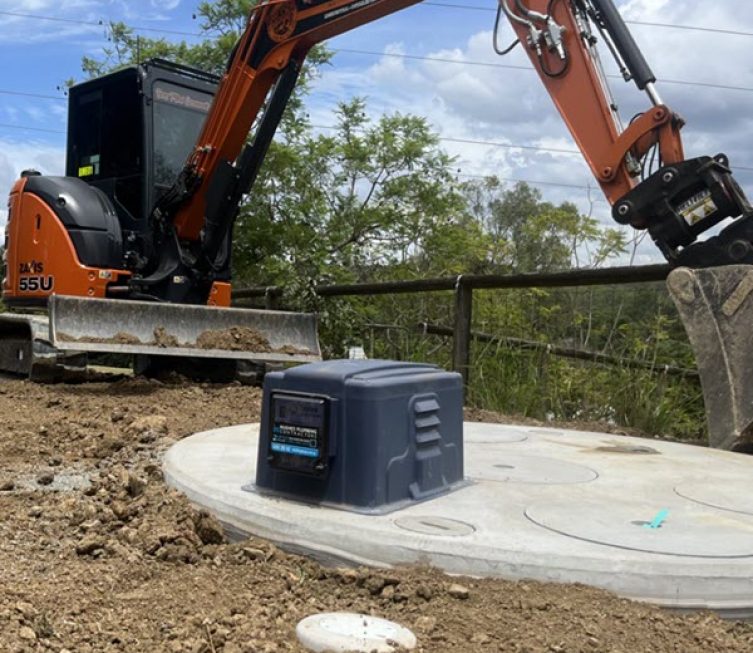 Excavator beside septic tank cover — Plumbing Contractors in Brisbane, QLD
